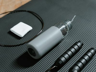 Minimalist fitness equipment on a dark grey mat